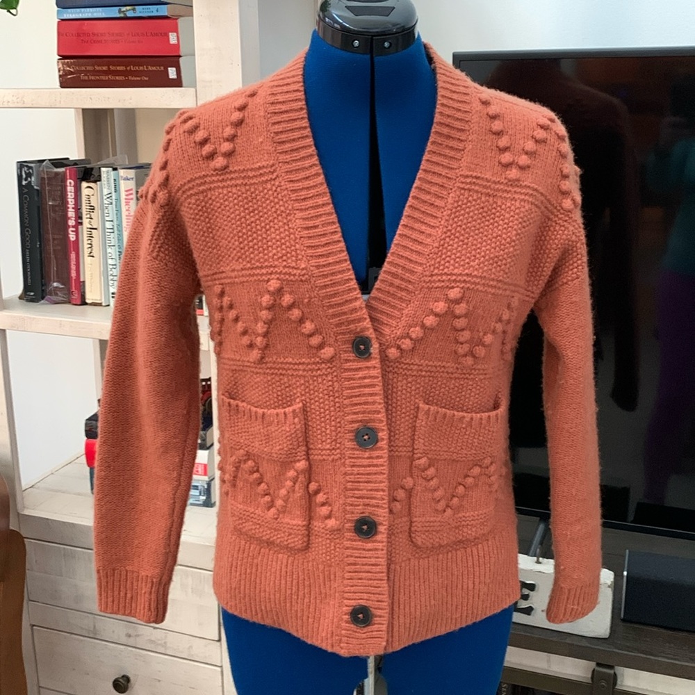 Madewell size XS cardigan in burnt orange. V neck, patch pockets and side slits.